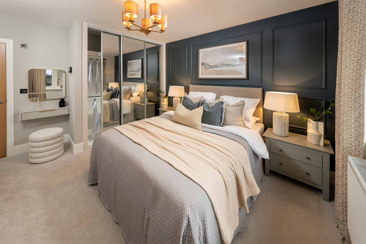 blue and cream coloured bedroom with made up bed and walk in wardrobe to the rear